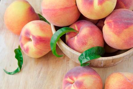 Peaches on wooden backgroundの写真素材