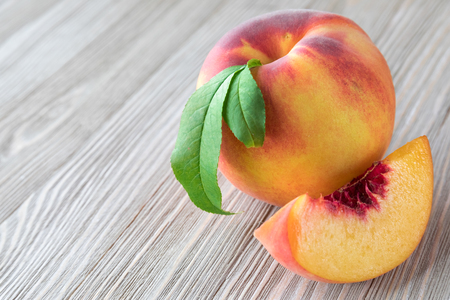 Peaches on wooden background with copy spaceの写真素材