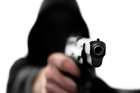 Unrecognizable man in hooded sweatshirt with handgun isolated on white backgroundの写真素材