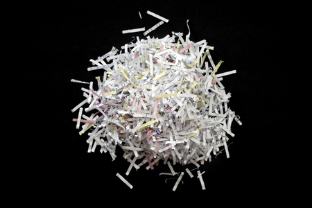 Shredded documents over black background