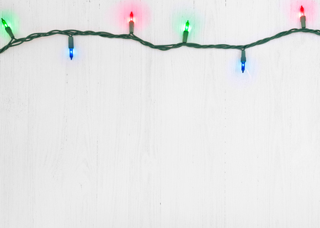 Christmas lights over wooden textured backgroundの写真素材