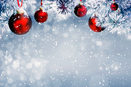 Christmas background with red ornaments and falling snowの写真素材