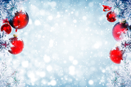Christmas background with red ornaments and falling snowの写真素材