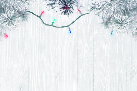 Holiday background, frosted pine tree branches over wooden textureの写真素材