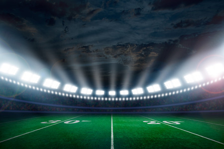 American football field illuminated by stadium lightsの写真素材