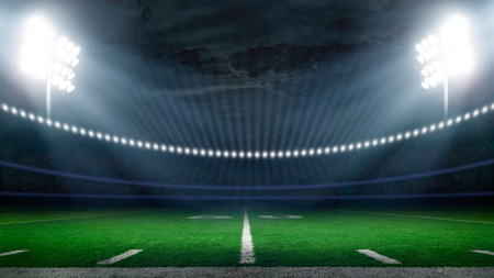 American football field illuminated by stadium lightsの写真素材