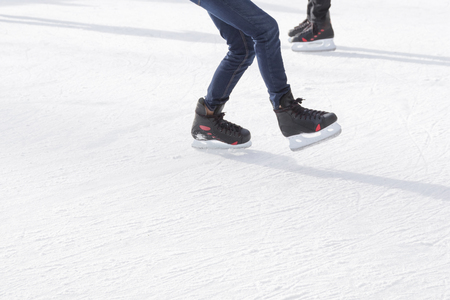 People ice skating on ice rinkの写真素材