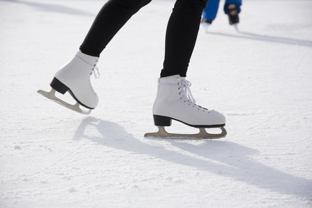 People ice skating on ice rinkの写真素材