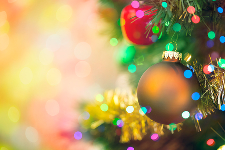Christmas tree decorated with ornaments and multi colored lights with copy spaceの写真素材