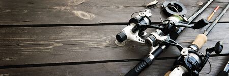 Fishing rods and accessories on wooden  with text space