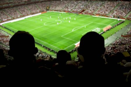 Soccer stadium with people watching game in progressの写真素材