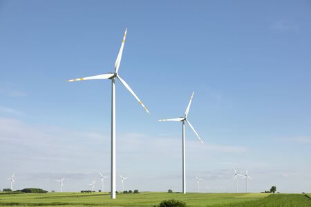 wind turbines in green field, countryside area with blue skyの写真素材