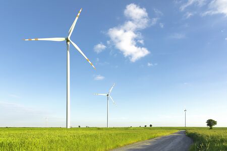 wind turbines in green field, countryside area with blue skyの写真素材