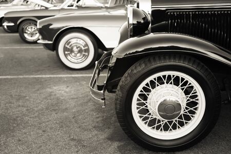 Classic cars parked in a row on the streetの写真素材
