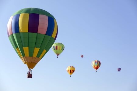 colorful hot air balloons in blue skyの写真素材