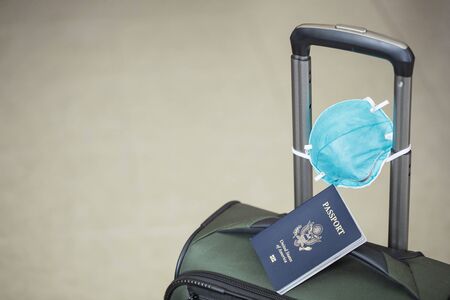 personal luggage with passport and flu virus mask to protect against coronavirus, global epidemic conceptの写真素材
