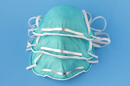 medical masks to protect against flu, virus on blue background, coronavirus conceptの写真素材