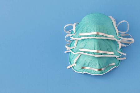 medical masks to protect against flu, virus on blue background, coronavirus concept