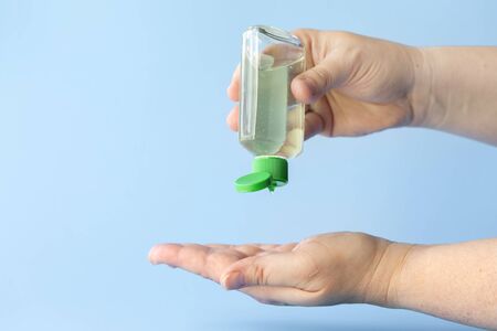 using small portable antibacterial hand sanitizer to protect against covid-19 flu viruses, coronavirus pandemicの写真素材