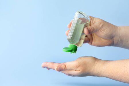 using small portable antibacterial hand sanitizer to protect against covid-19 flu viruses, coronavirus pandemicの写真素材