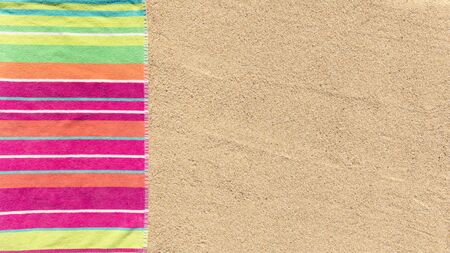 Beach towel photographed from above on sandy beach with copy spaceの写真素材