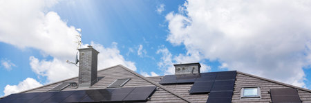 Solar panels on the house roof in sunny day. Renewable clean green energy generation.の写真素材