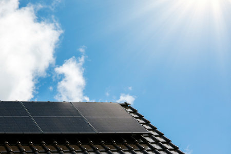 Solar panels on the house roof in sunny day. Renewable clean green energy generation.の写真素材