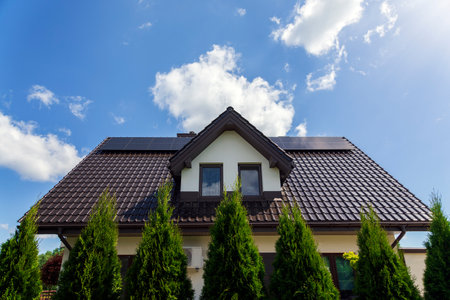Solar panels on the house roof in sunny day. Renewable clean green energy generation.の写真素材