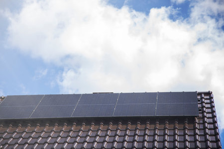 Solar panels on the house roof in sunny day. Renewable clean green energy generation.の写真素材