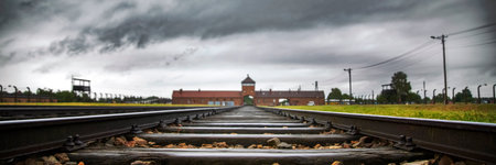 Railroad track to main gate of Auschwitz former German concentration and extermination camp in Polandのeditorial素材