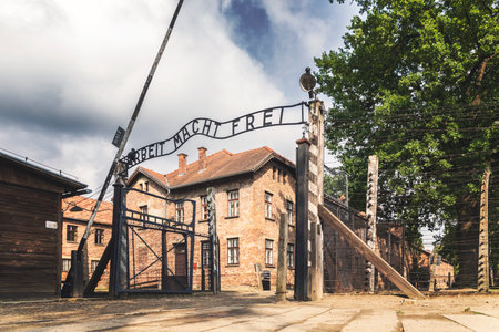 Entrance gate to former German Nazi concentration and extermination camp in Auschwitz Polandのeditorial素材