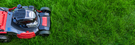 Lawn mower on green grass. Top view. Copy spaceの写真素材