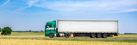 Truck with a trailer on the road in the field. Cargo transportationの写真素材