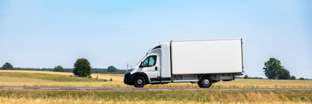White commercial delivery truck on the road. Panoramic view.の写真素材
