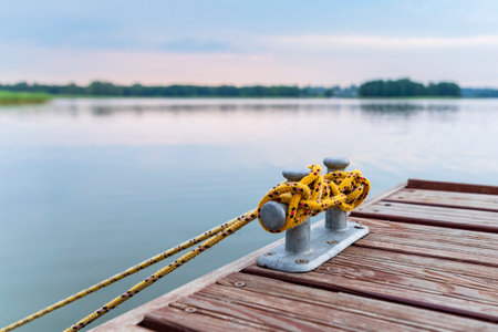 Bollard on a wooden pier on the background of the lakeの写真素材