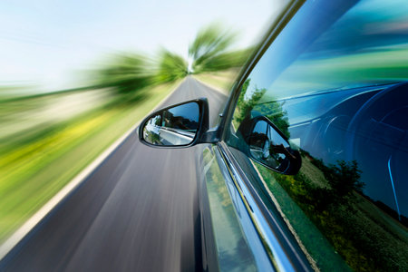 car on the road with motion blur background. rear view mirror.の写真素材
