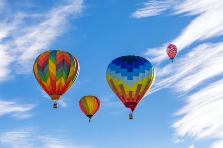 Colorful hot air balloons in the blue sky with white clouds.の写真素材