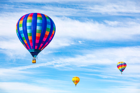 Hot air balloon against blue sky with white clouds. Colorful hot air balloonsの写真素材