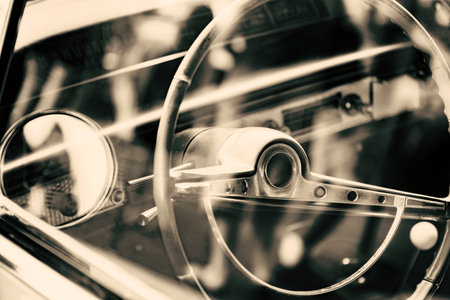 Detail of the steering wheel and dashboard of a vintage car.の写真素材