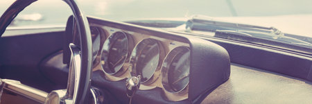 Retro car interior. Vintage car dashboard and steering wheel close upの写真素材
