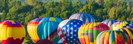 Colorful hot air balloons flying in the sky at the festival.の写真素材