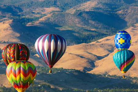 Hot air balloons flying over the mountains. Colorful hot air balloonsの写真素材