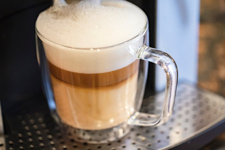 coffee latte in a glass on the coffee machine, stock photoの写真素材