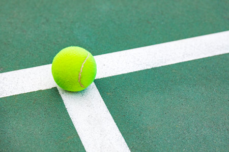 Tennis ball on the tennis court with white line, sport backgroundの写真素材