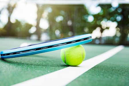 Tennis racket and ball on the tennis court. Sport concept.の写真素材