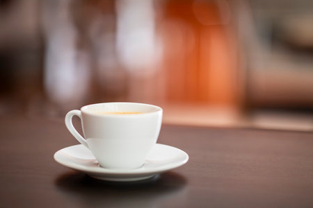 coffee cup on the table in coffee shop blur background with bokehの写真素材