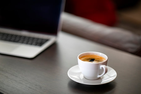 Coffee cup on wooden table in coffee shop, stock photoの写真素材