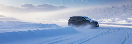 Car on the road in the winter forest. Panoramic view.の素材