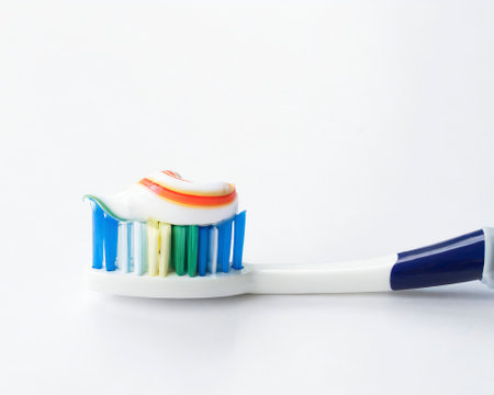 Toothbrush with toothpaste on white background. Close up.の素材