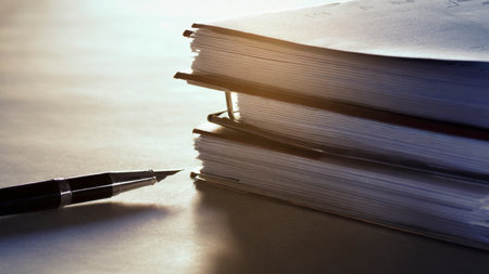 Pen and book on the table. Selective focus and shallow depth of field.の素材